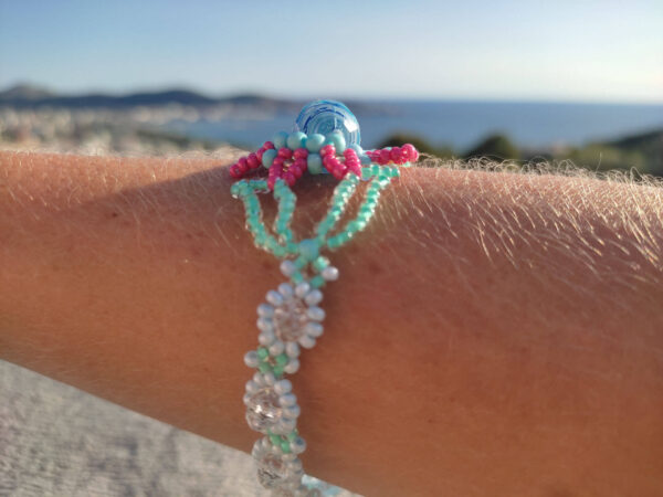 Universal flower of life - on hand and sea view