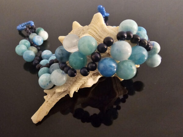 Emotionally healing flow gemstone bracelet on a shell