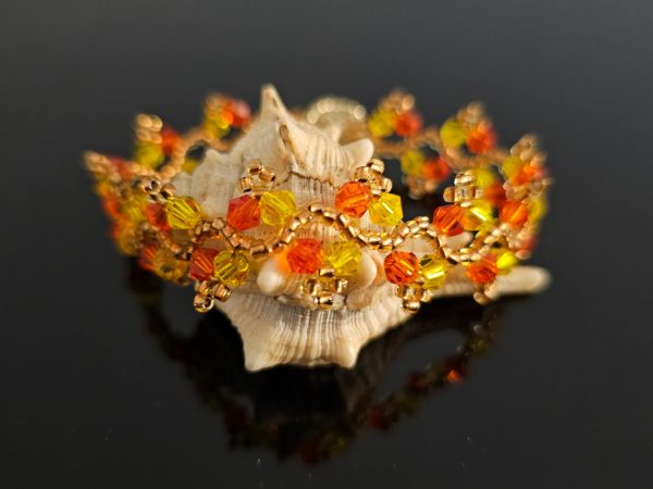 Golden thread bracelet on a shell