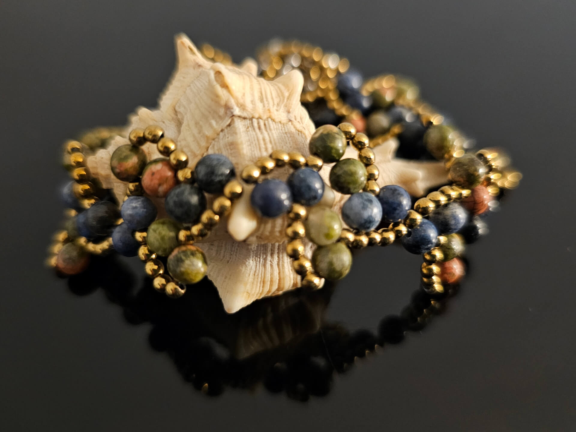 Grounding Stillness gemstone bracelet on a shell